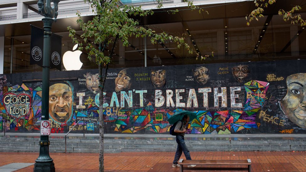 A mural reading "I can't breathe" with images of George Floyd