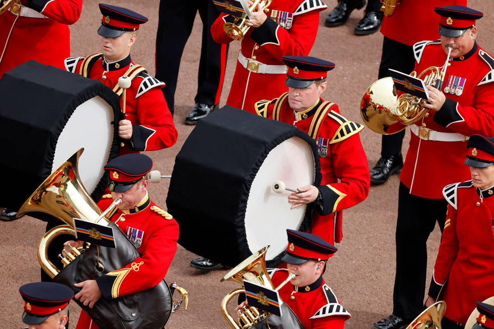 A military band passes.