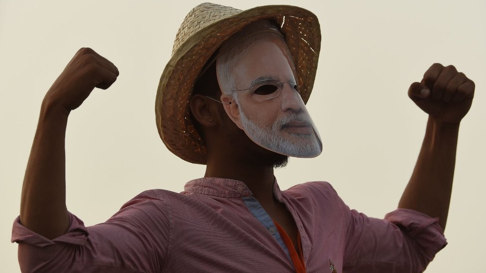 Bharatiya Janata Party (BJP) supporter gestures as Indian Prime Minister Narendra Modi (not pictured) delivers a speech during a rally ahead of Phase VI of India's general election in New Delhi on May 8, 2019.