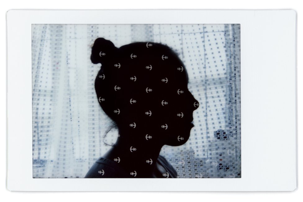A composite image showing the profile of Liudmila with a patterned baby blanket over the top