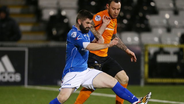 Dungannon's Cormac Burke battles with Carrick's Andrew Doyle at Seaview
