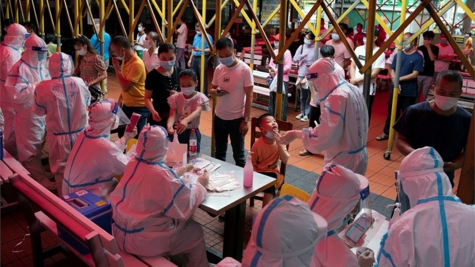Residents line up for nucleic acid testing at a night market following a new case of the coronavirus disease (COVID-19) in Haikou, Hainan province, China 3 August 2021