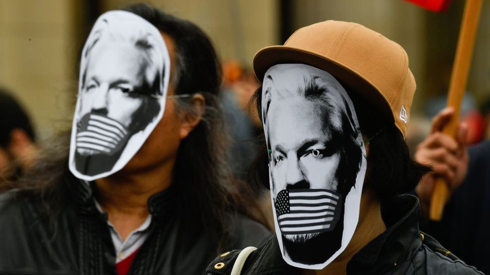 Demonstrators protest with masks of WikiLeaks founder Julian Assange during a Pro-Assange demo in Germany
