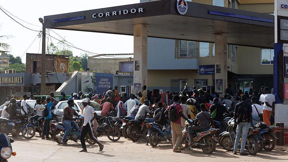 Malian women waiting for transport