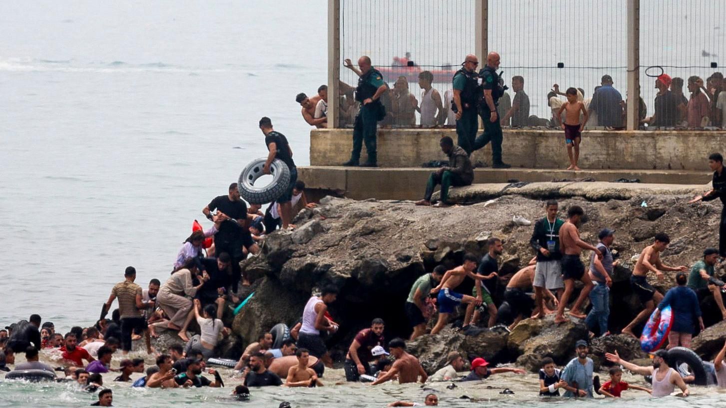 Hundreds of migrants swim from Morocco to Ceuta as territory leader warns of overwhelming resources and humanitarian emergency