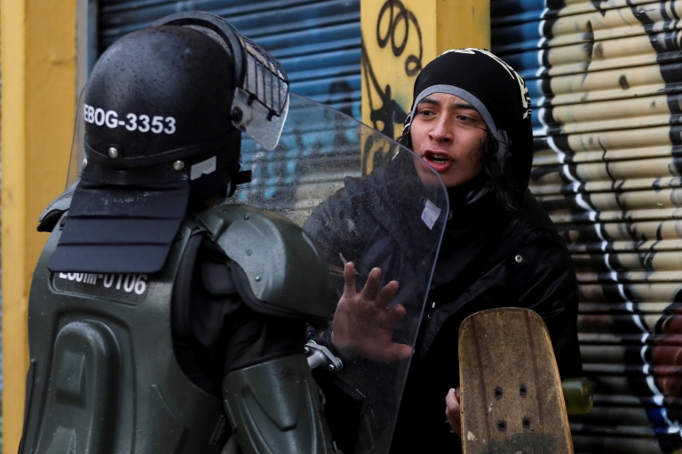 A person talks to a police officer during a protest against the tax reform of President Ivan Duque's government in Bogota, Colombia, May 1, 2021. 
