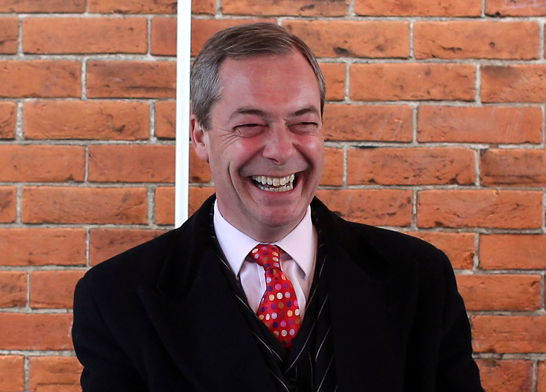 Nigel Farage grinning while seated