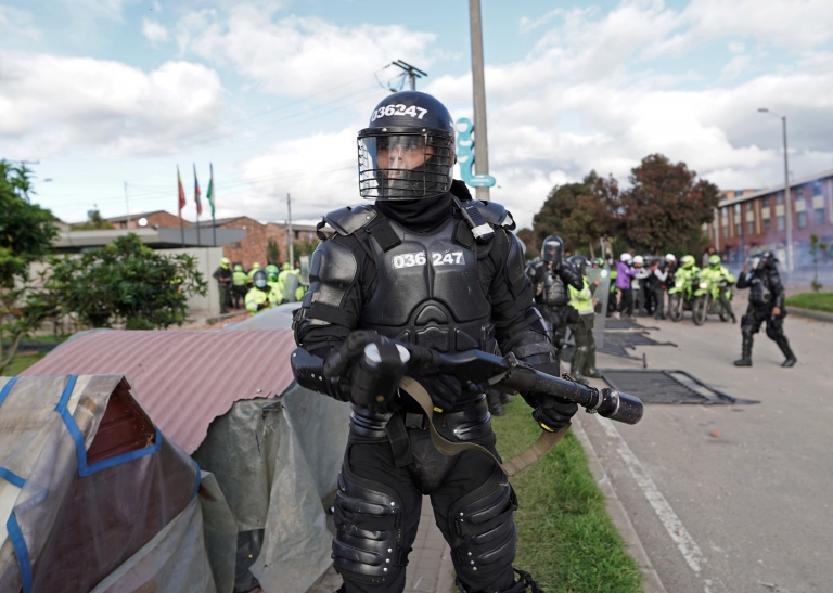 A police officer looks on during clashes with demonstrators as anti-government protests take place in Bogota, Colombia, June 29, 2021.