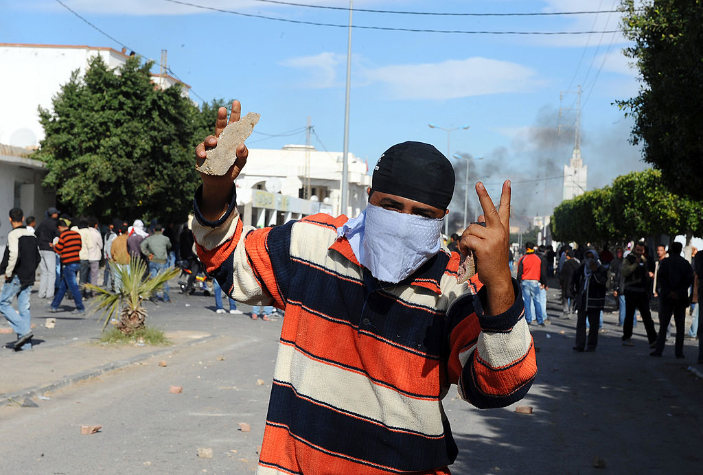 Protester wearing a bandanna over his face