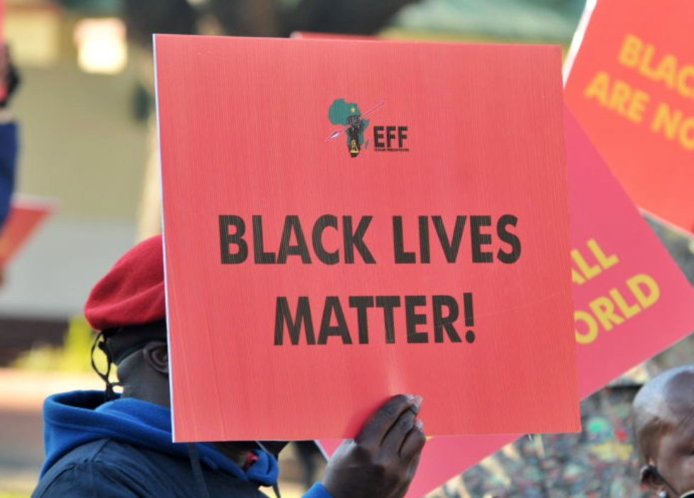 Someone holding up an EFF sign that says: 