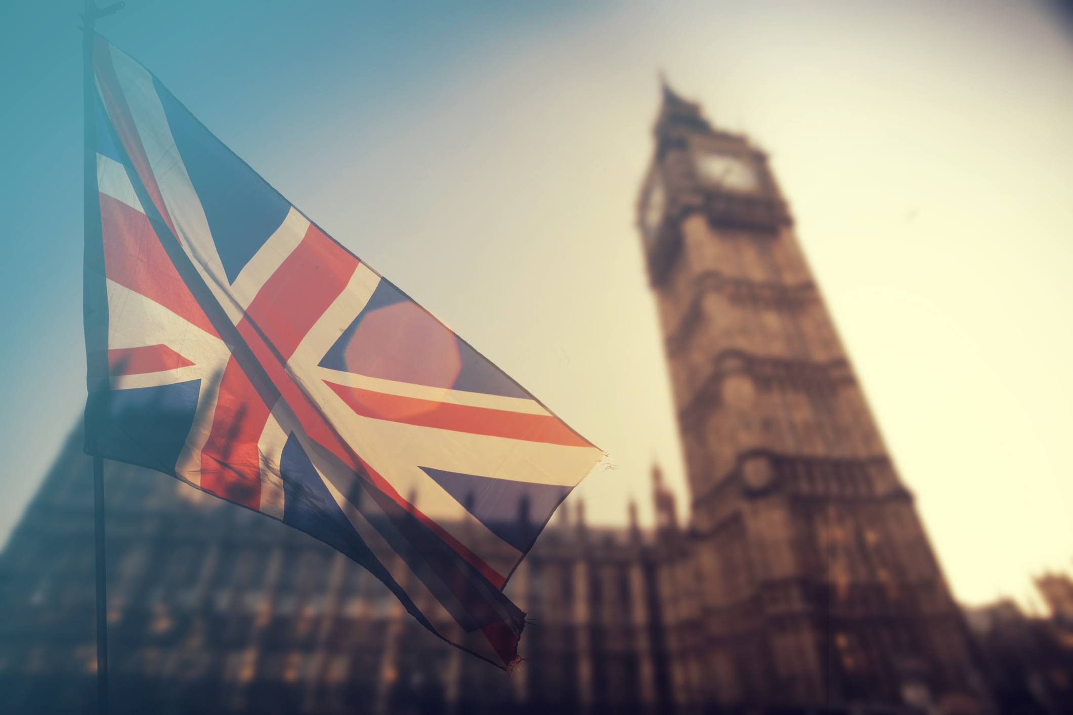 Houses of Parliament with a Union Jack flag in front of it