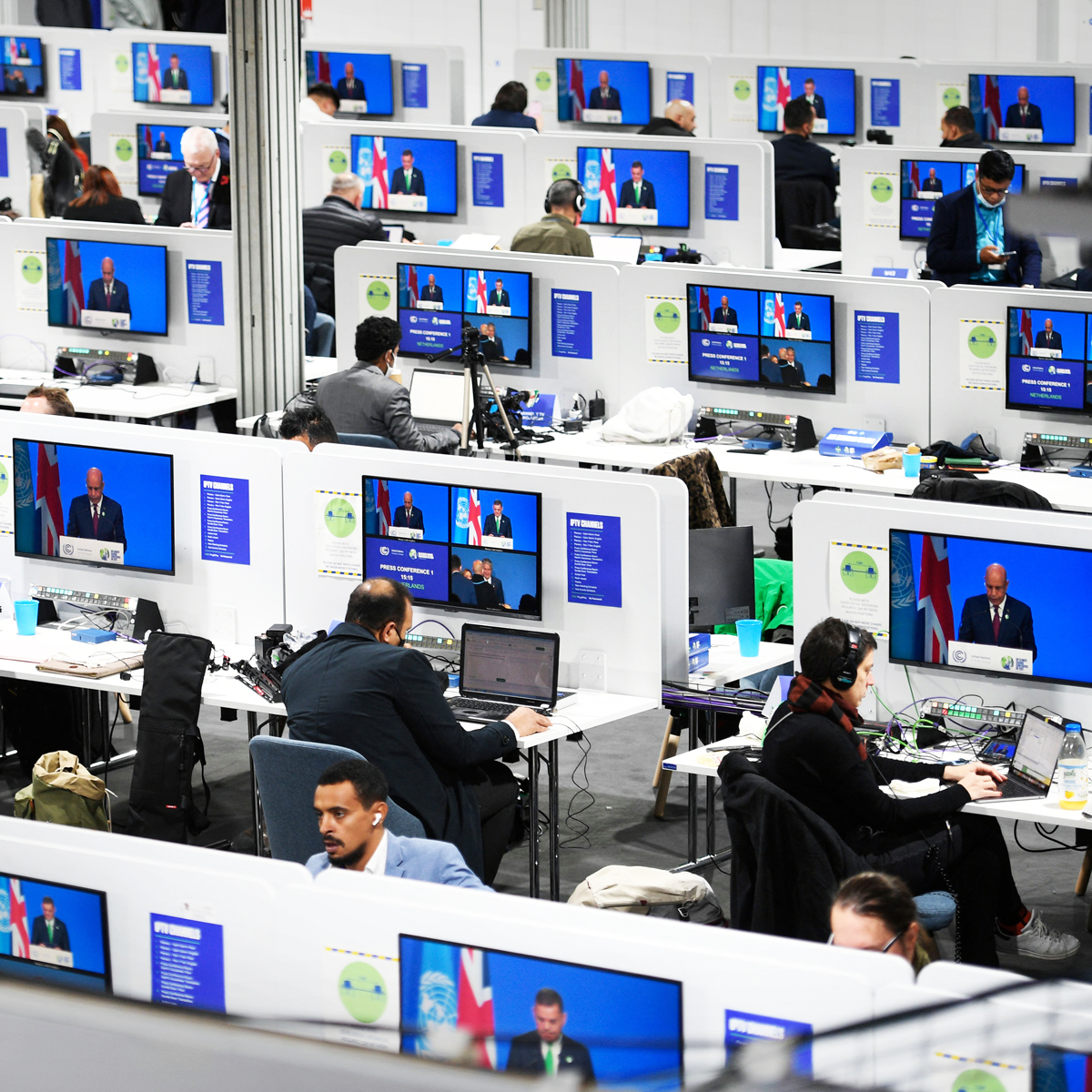 Journalists work inside the media centre at the COP26