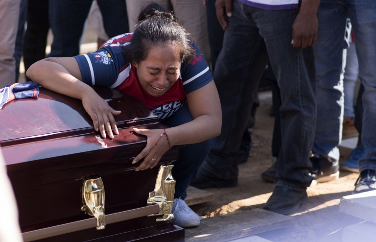 A woman cries as she mourns the victim of a shooting in Minatitlan in Mexico on 21 April 2019