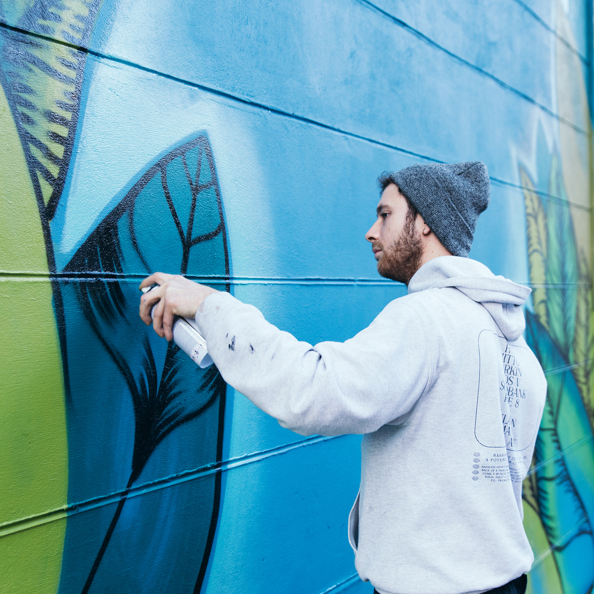 Daniel Rupaszov painting a mural