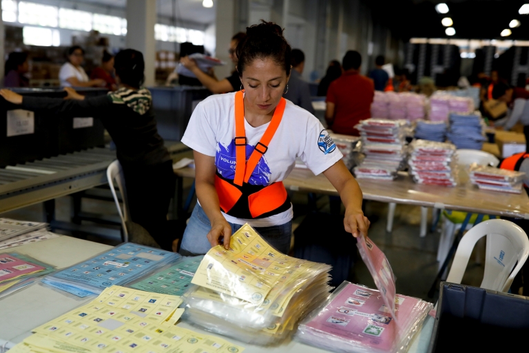 A woman sorts ballot papers at a warehouse in Guatemala City.