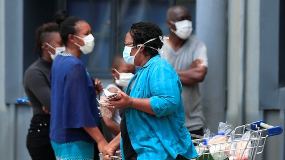 A woman leaves a supermarket  in Harare, Zimbabwe