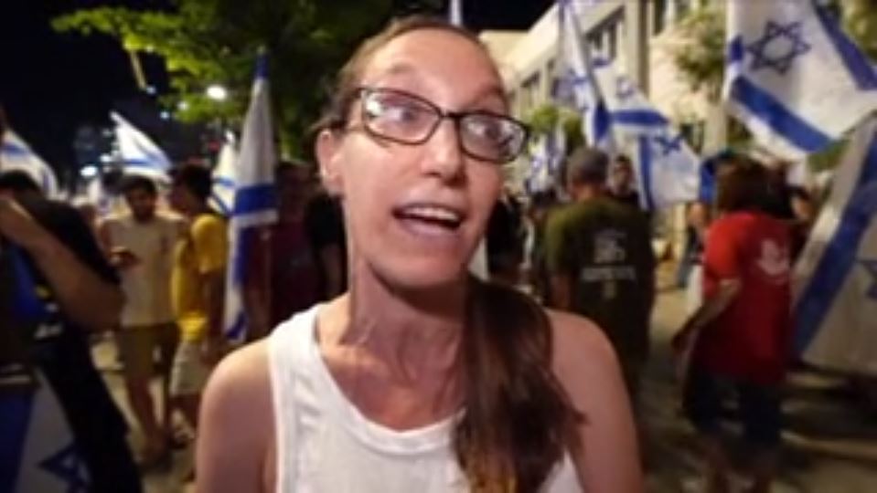 Sarah, a protester, speaks on camera
