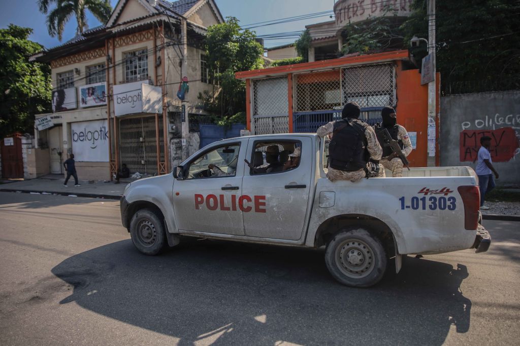 Armed police travel in the back of a truck through the streets of the Haitian capital Port-au-Prince.