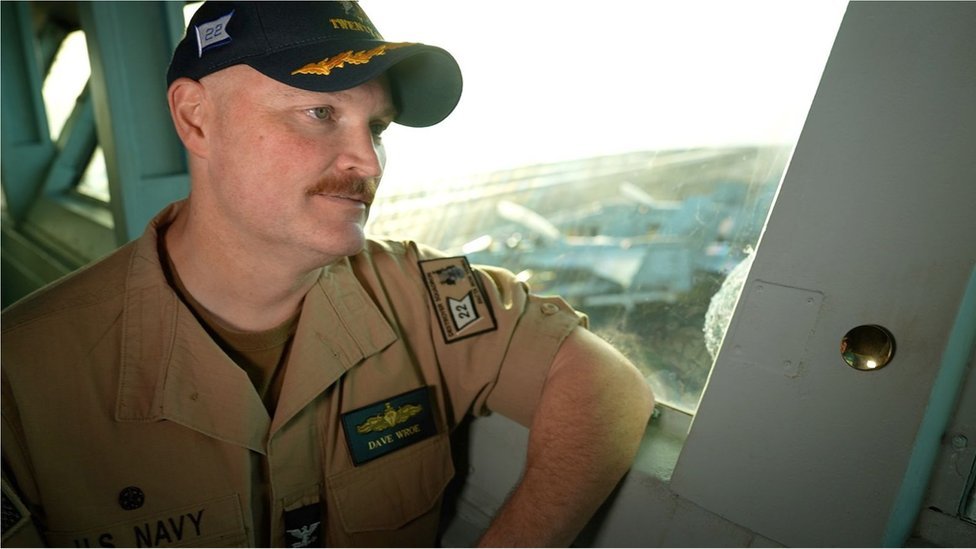 Captain Dave Rowe sits on aircraft carrier