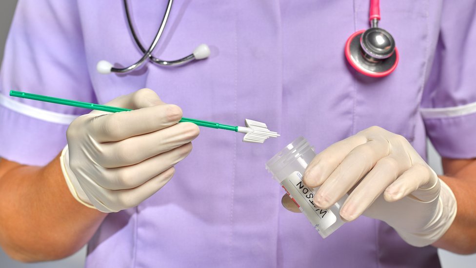 A nurse preparing to carry out a smear test