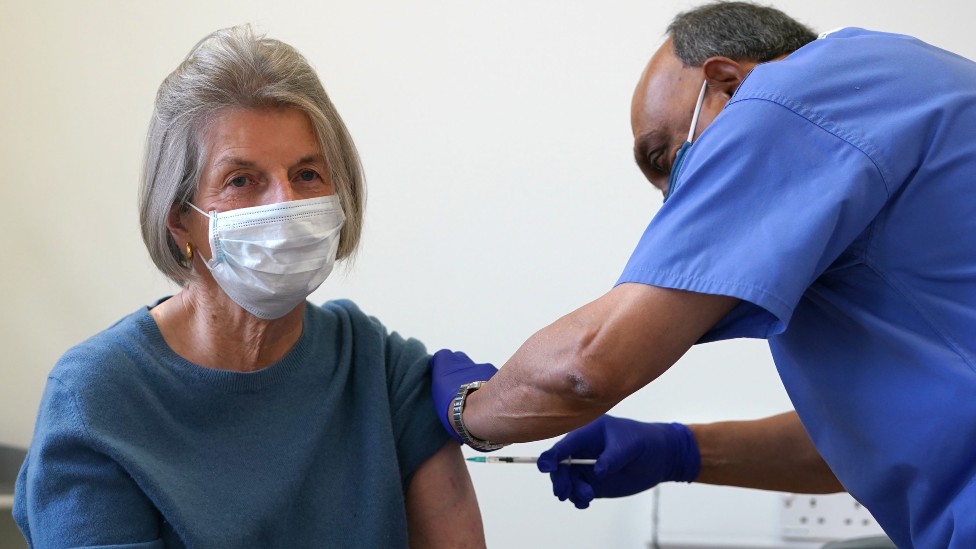 Doctor Abhi Mantgani administers a Covid-19 vaccine booster to Shirley Davies, Birkenhead, Merseyside