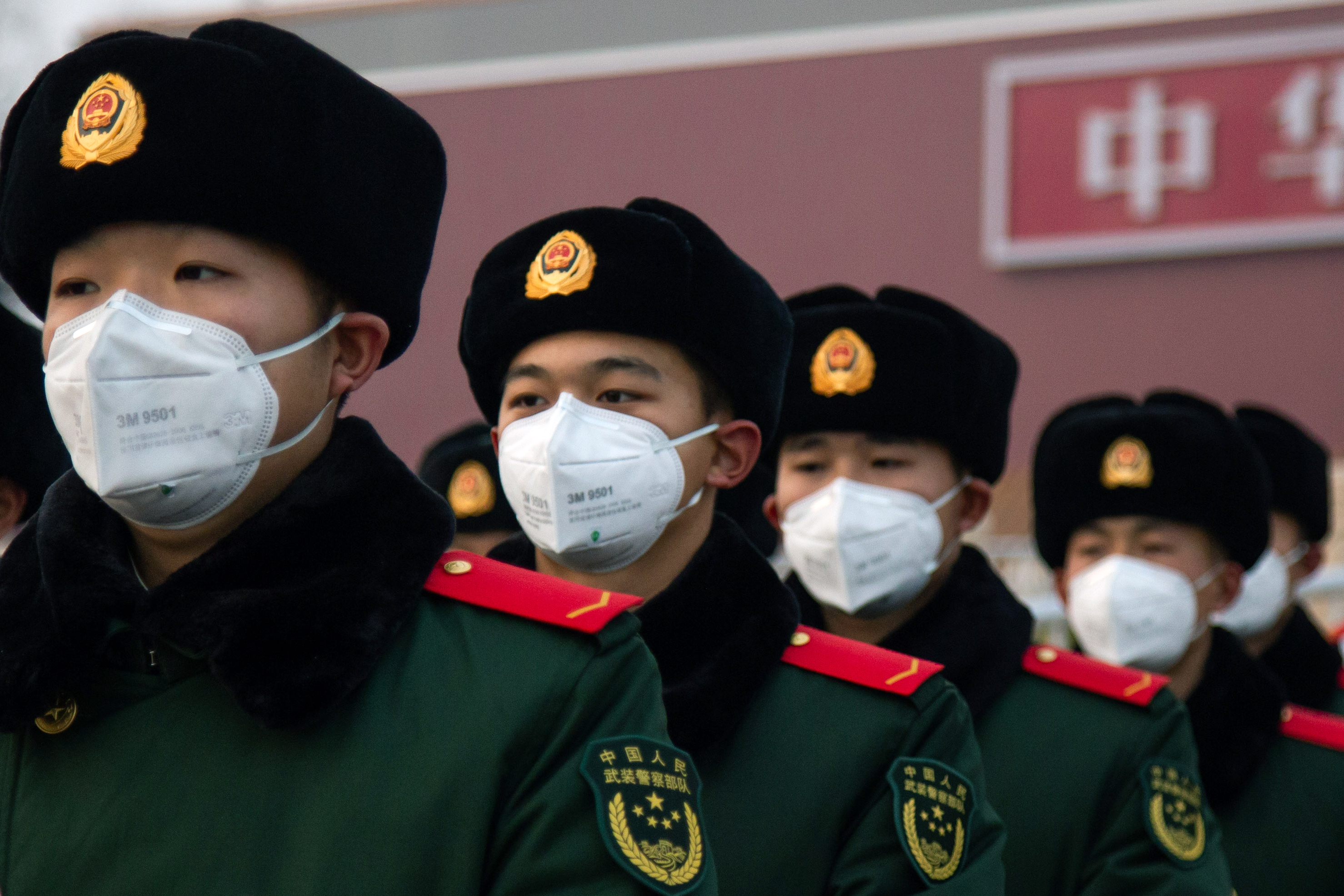 Chinese policemen wearing masks