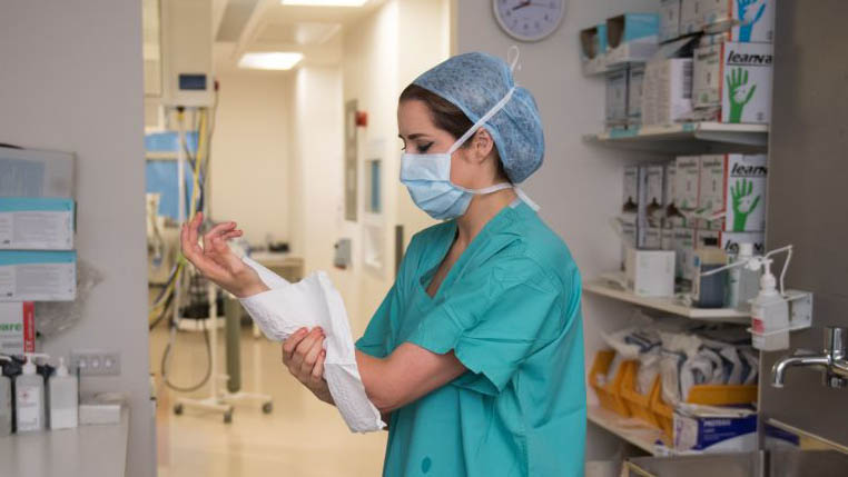 A surgical care practitioner preparing to enter an operating theatre