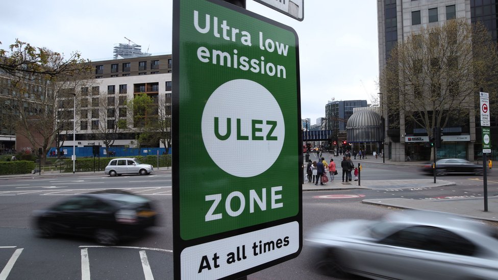 A ULEZ sign in front of a busy multi-lane road.