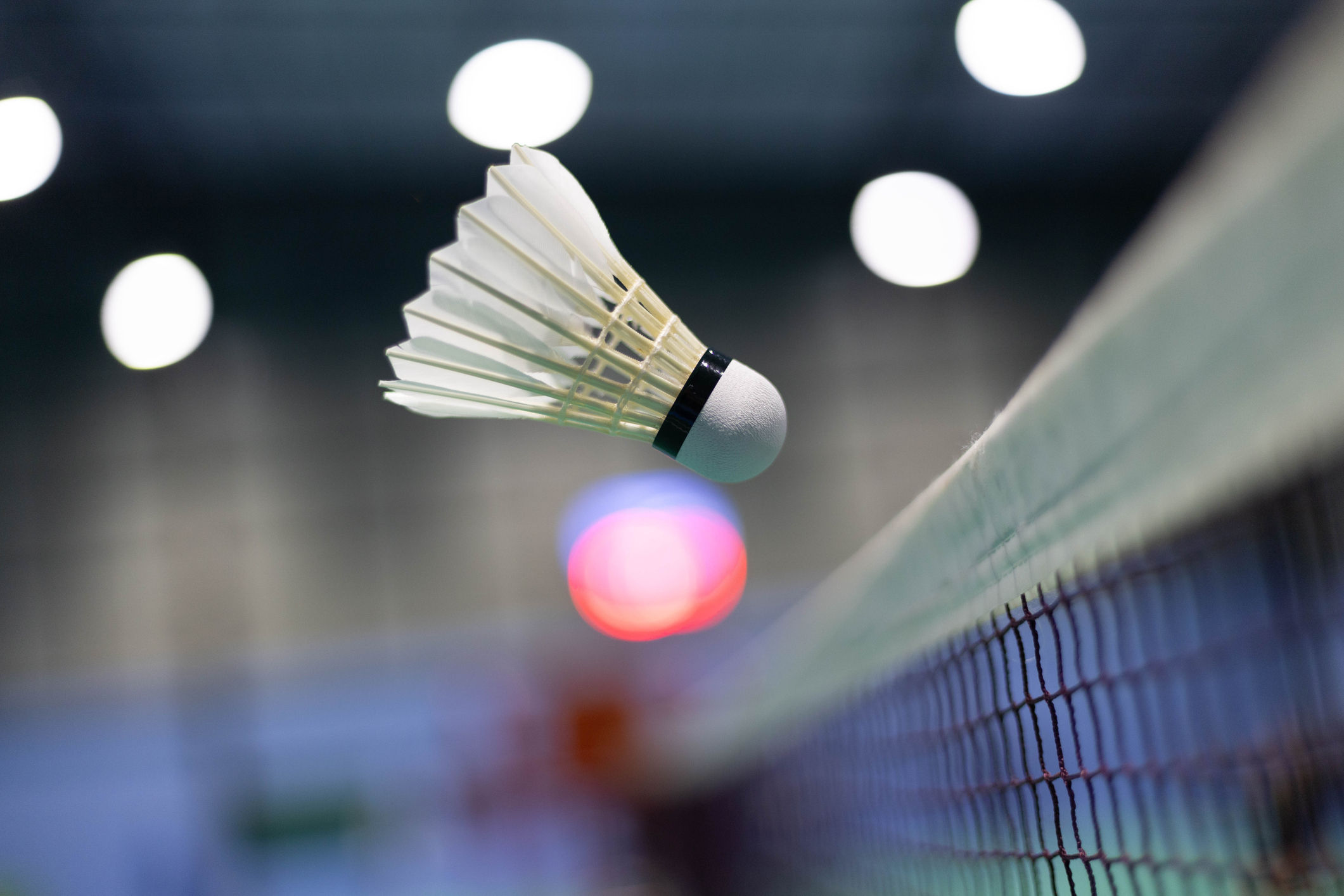 A shuttlecock flying towards the net