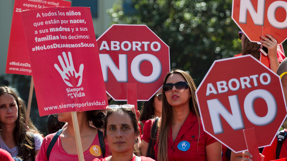 An activist takes part in a protest against abortion in front of La Moneda presidential Palace in Santiago on March 21, 2016.