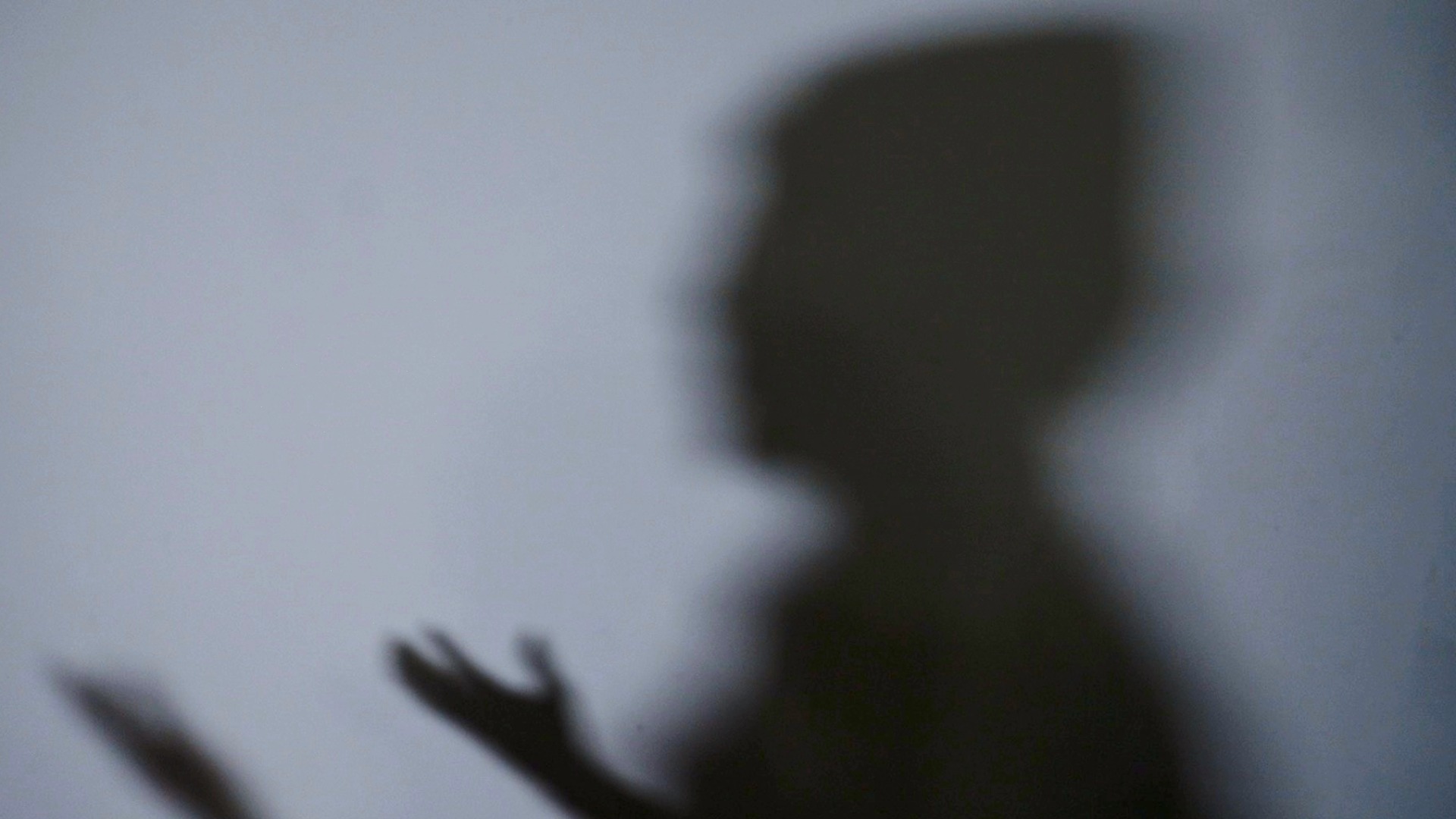 The shadow of Abdi on a wall