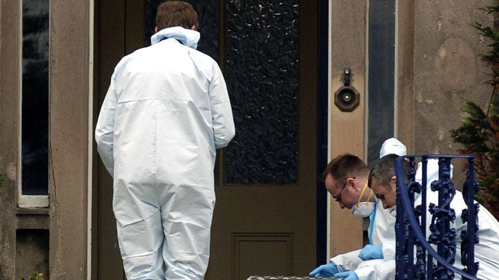 Police forensic officers at the front door of the Wilson's home.