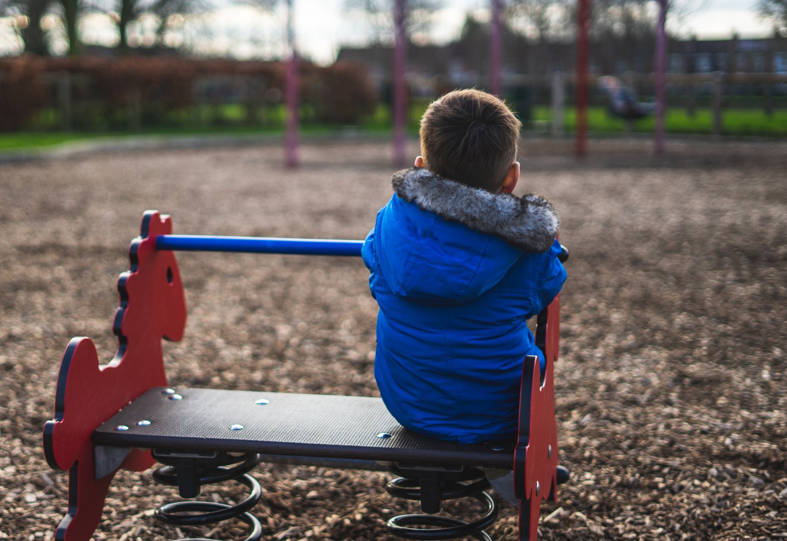 A stock image of a child sat depressed and alone 