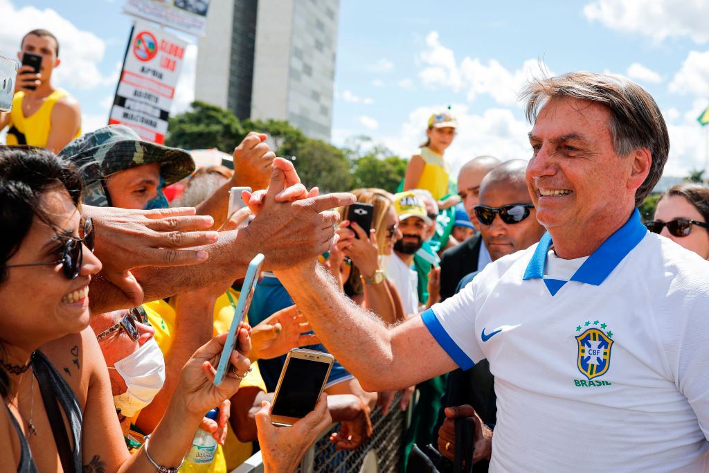 Brazilian president Jair Bolsonaro greets supporters on 15 March