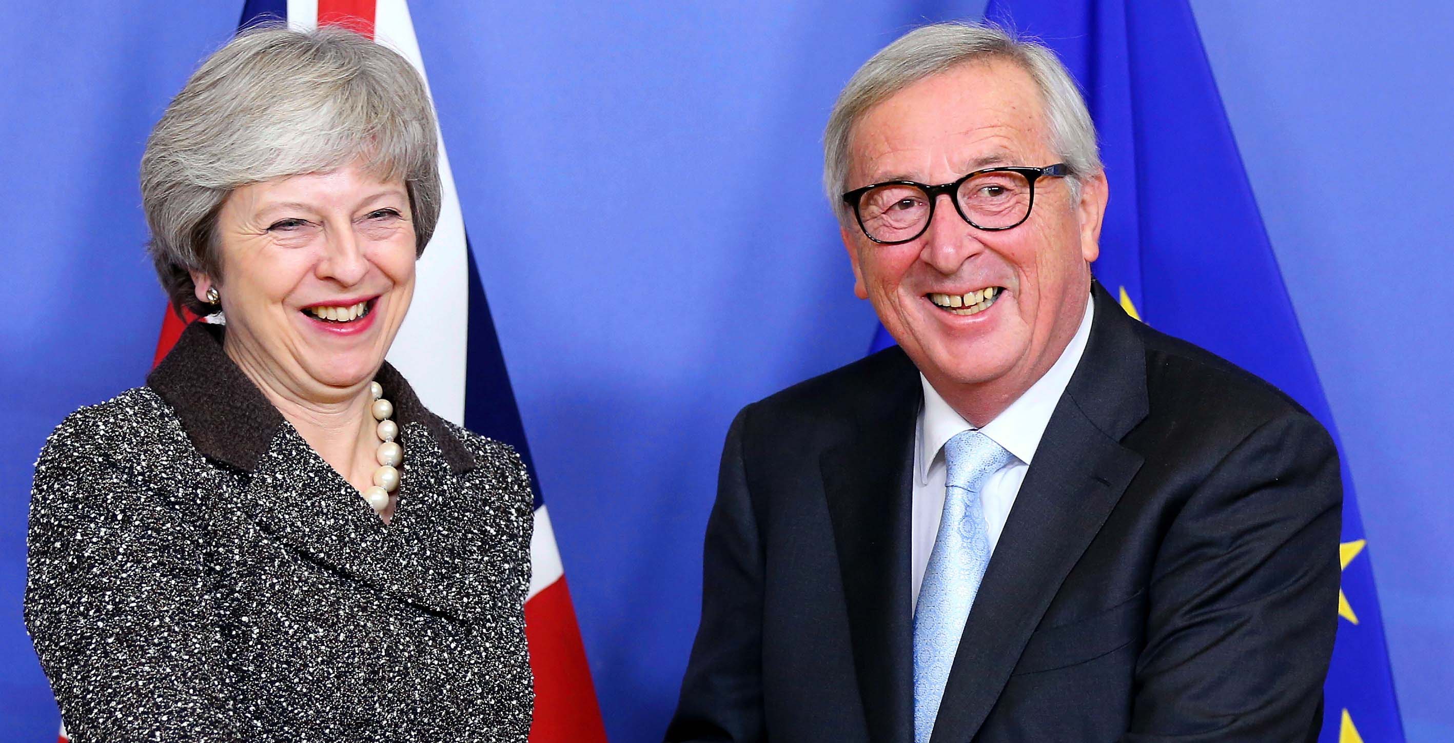 Theresa May and Jean-Claude Juncker shake hands