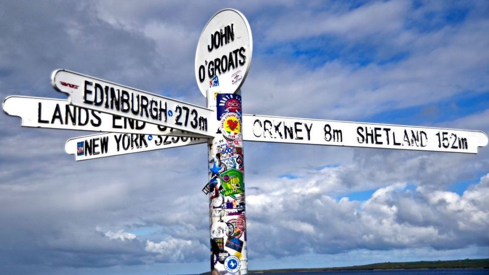 The John O' Groats sign showing distances to other locations including Lands End, Edinburgh, Orkney and Shetland.