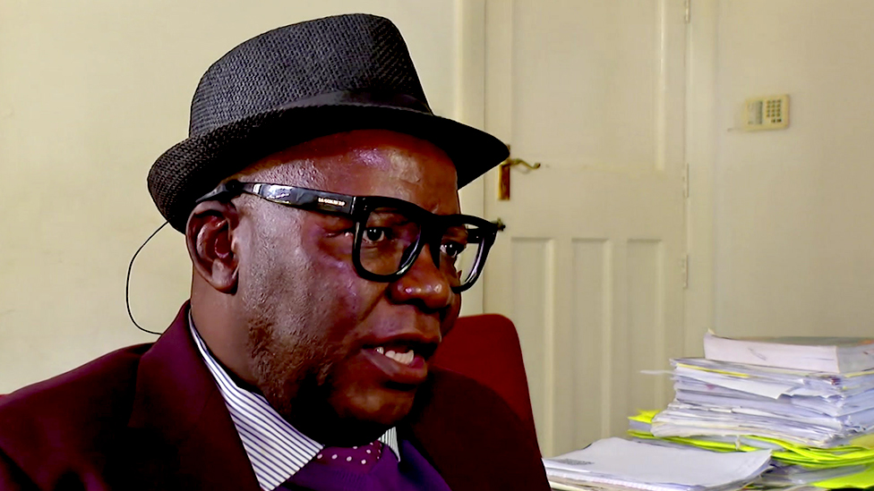 A head and shoulders image of Tendai Bit wearing a trilby hat.