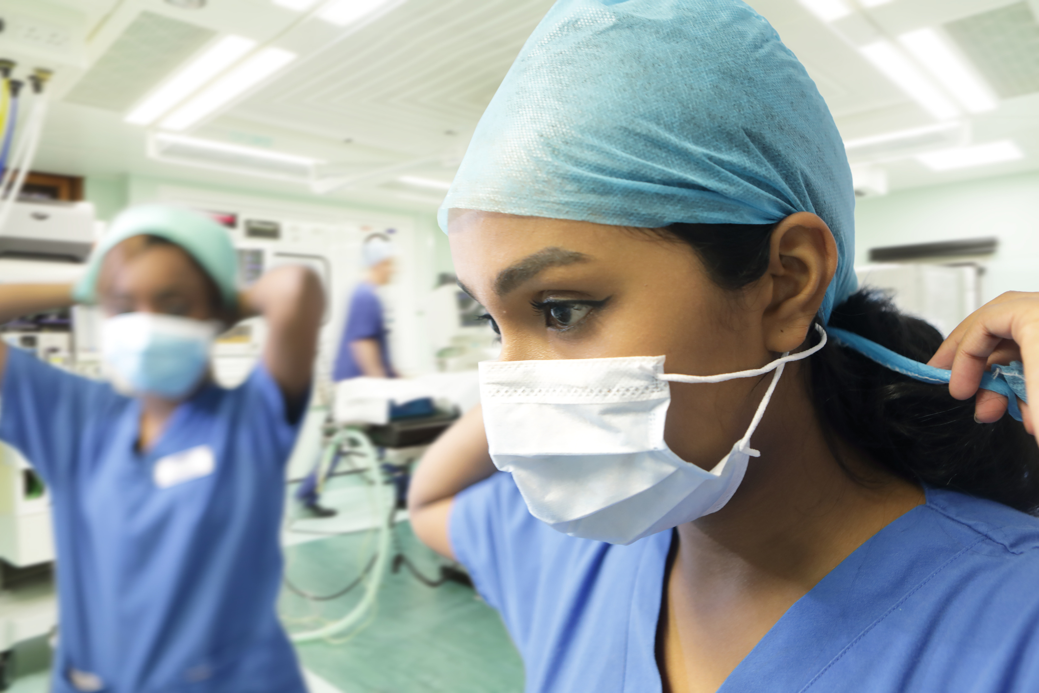 Doctors putting on PPE