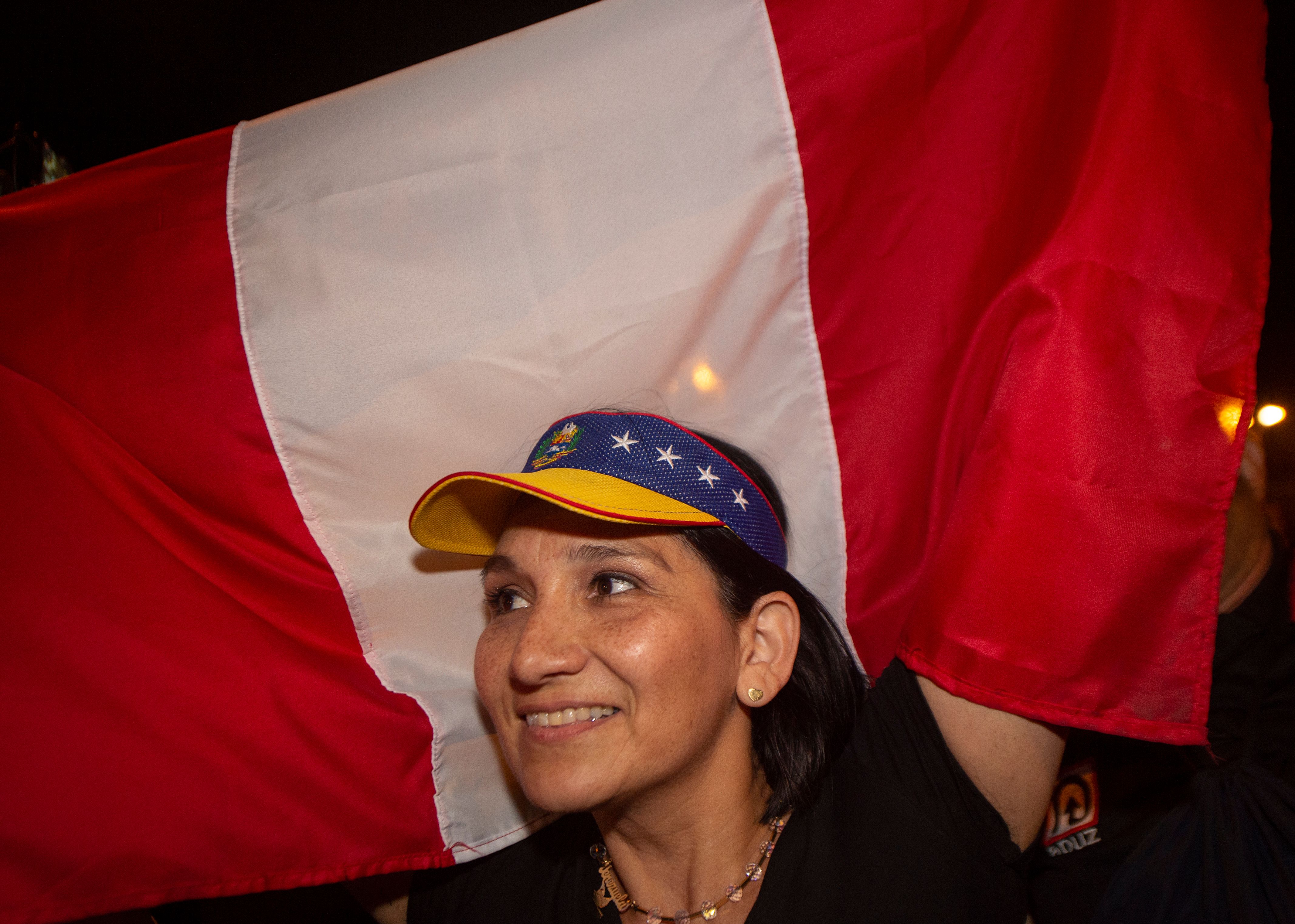 A Venezuelan woman waves a Peruvian flag at a protest against the government of President Maduro in Lima