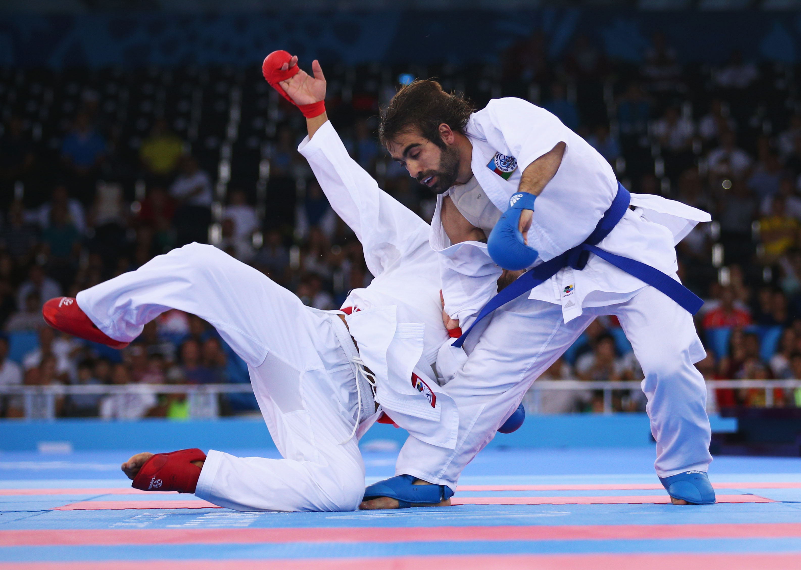 Rafael Aghayev of Azerbaijan (blue) competes with Luigi Busa of Italy (red) during the Men's Kumite -75kg final on day one of the Baku 2015 European Games, June 13, 2015.