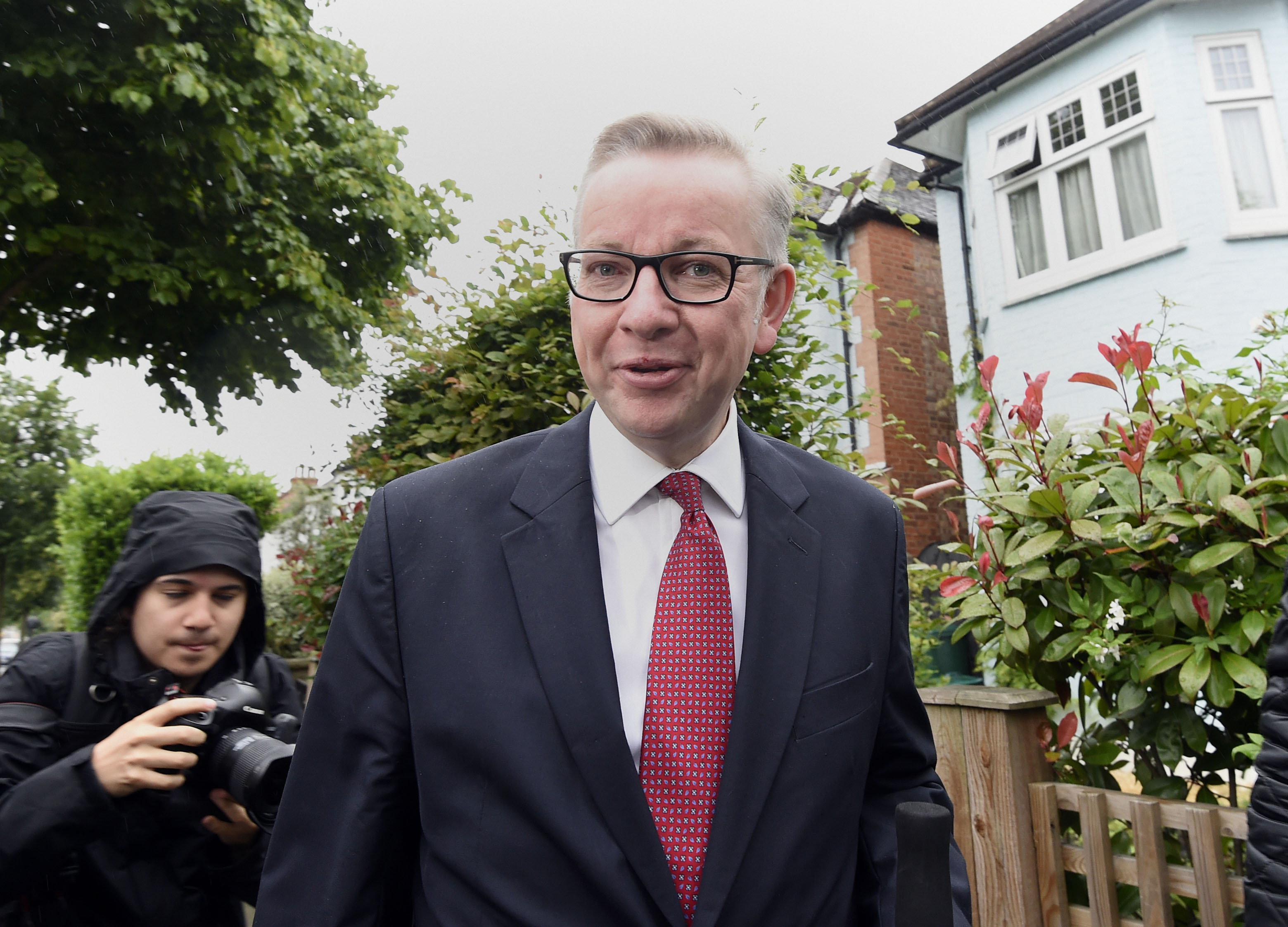 Michael Gove being met by press as he leaves his home