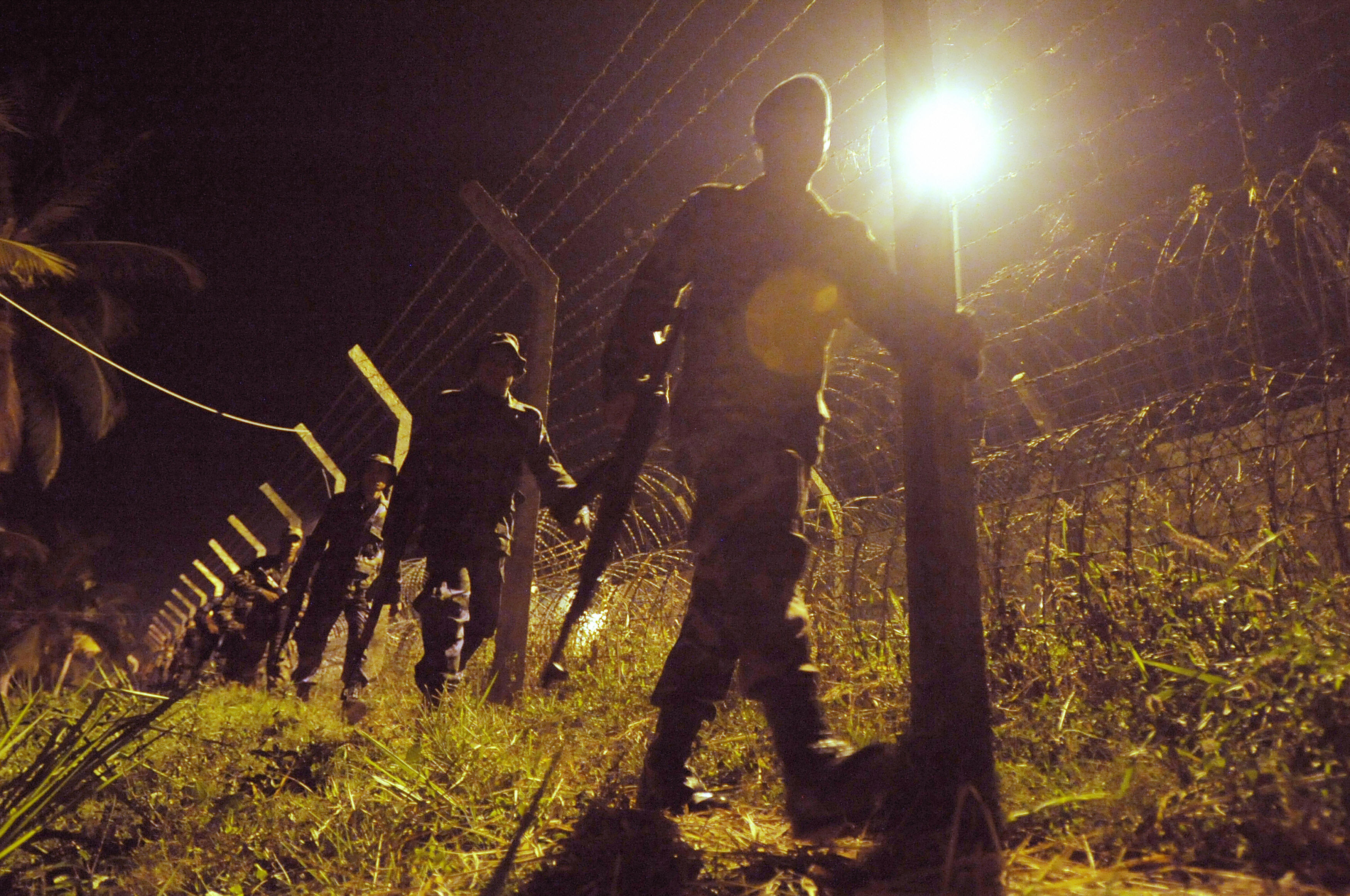 Sri Lankan soldiers patrol, late February 20, 2009 at Katunayake, near the international airport, at the crash-site of a rebel Tamil Tiger light aircraft which Sri Lanka's air forc