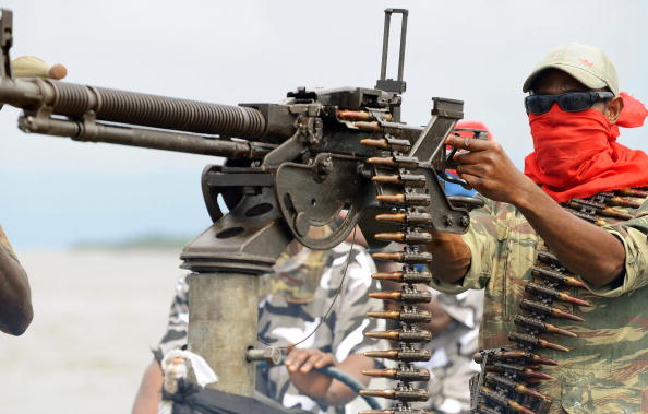 An oil militant in Nigeria's Niger Delta holding a machine gun