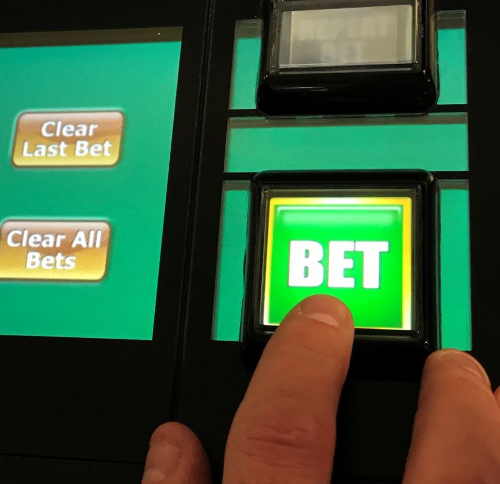 A man gambles on a fixed odds betting terminal inside a bookmakers