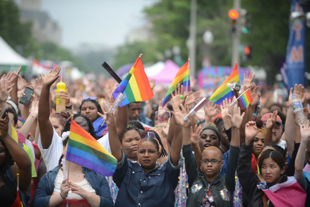 The crowd raises their hands in support of transgender members of the LGBTQ community during the Capital Pride Festival in 2019.
