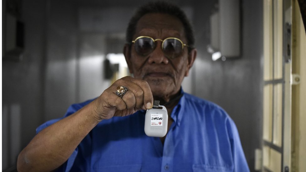 Elderly man with Bluetooth dongle