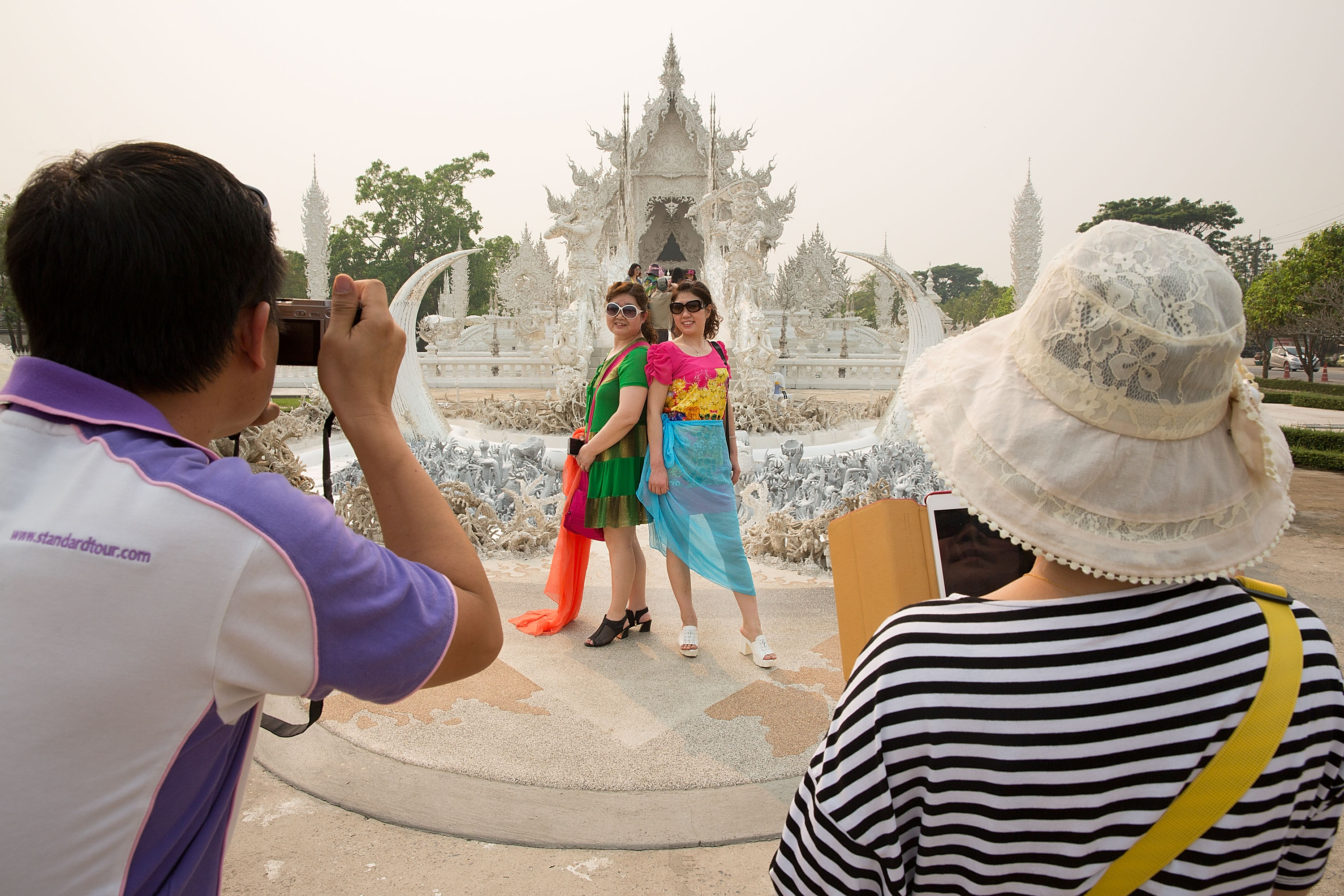 Chinese tourists take photos in Thailand.