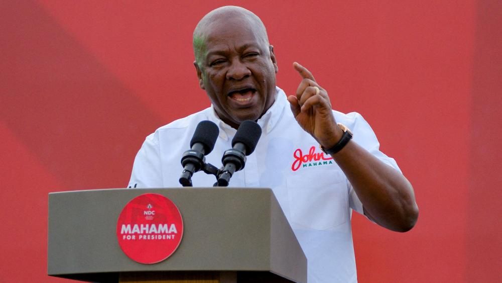 John Mahama, in a white T-shirt, speaks from the podium in Tamale, Ghana, on 27 July 2024