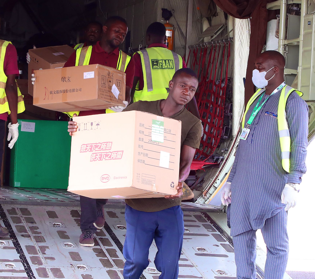 A man takes down a box of donations from a plane