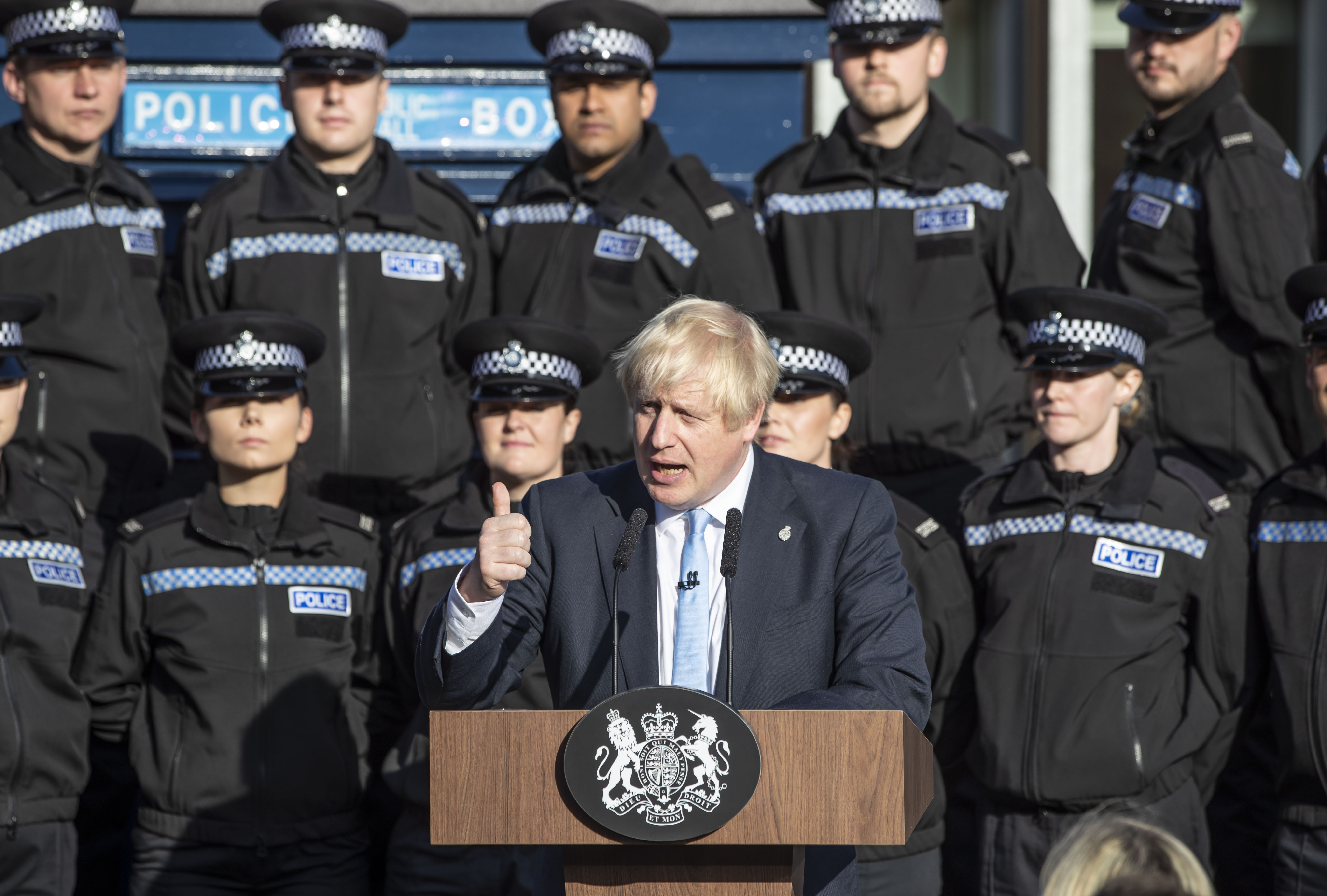 Boris Johnson standing in front of police officers